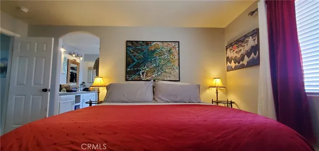 a bed sitting in a bedroom next to a window