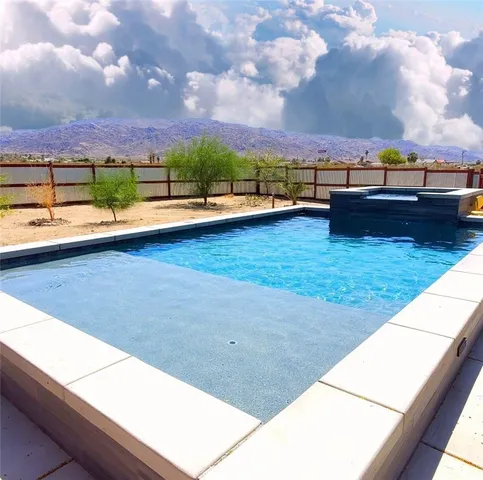 a view of swimming pool with outdoor seating