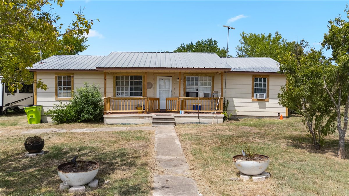 19016 Farm To Market Road 973 Coupland, TX 78615 - Photo 5 of 18 a view of a white house with a sink and plants