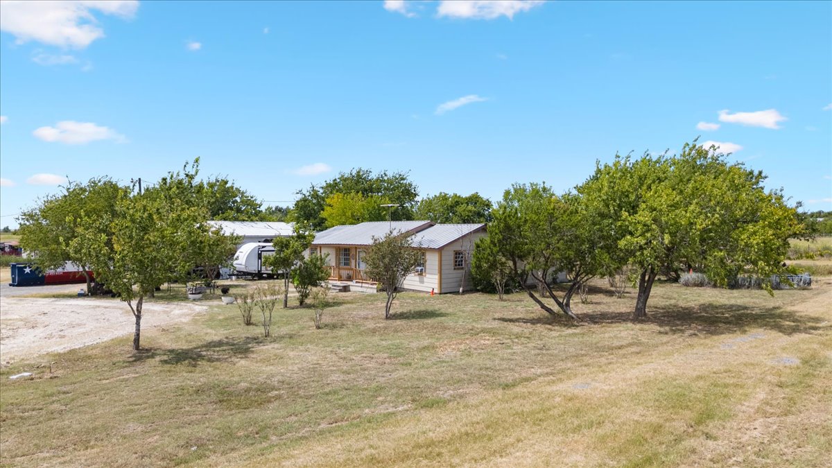 19016 Farm To Market Road 973 Coupland, TX 78615 - Photo 6 of 18 a view of a dry yard with wooden fence