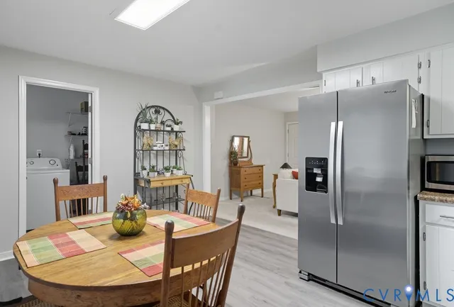 a dining room with wooden floor a glass table and chairs