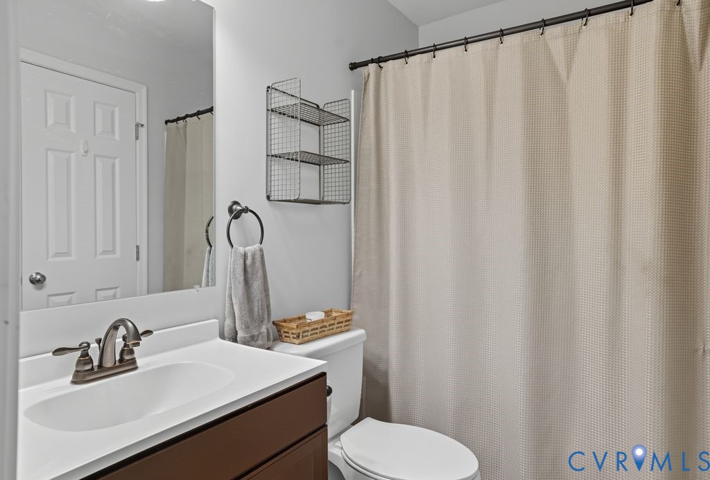 3403 Fallbrooke Court North Chesterfield, VA 23235 - Photo 13 of 23 a bathroom with a sink a toilet and shower curtain
