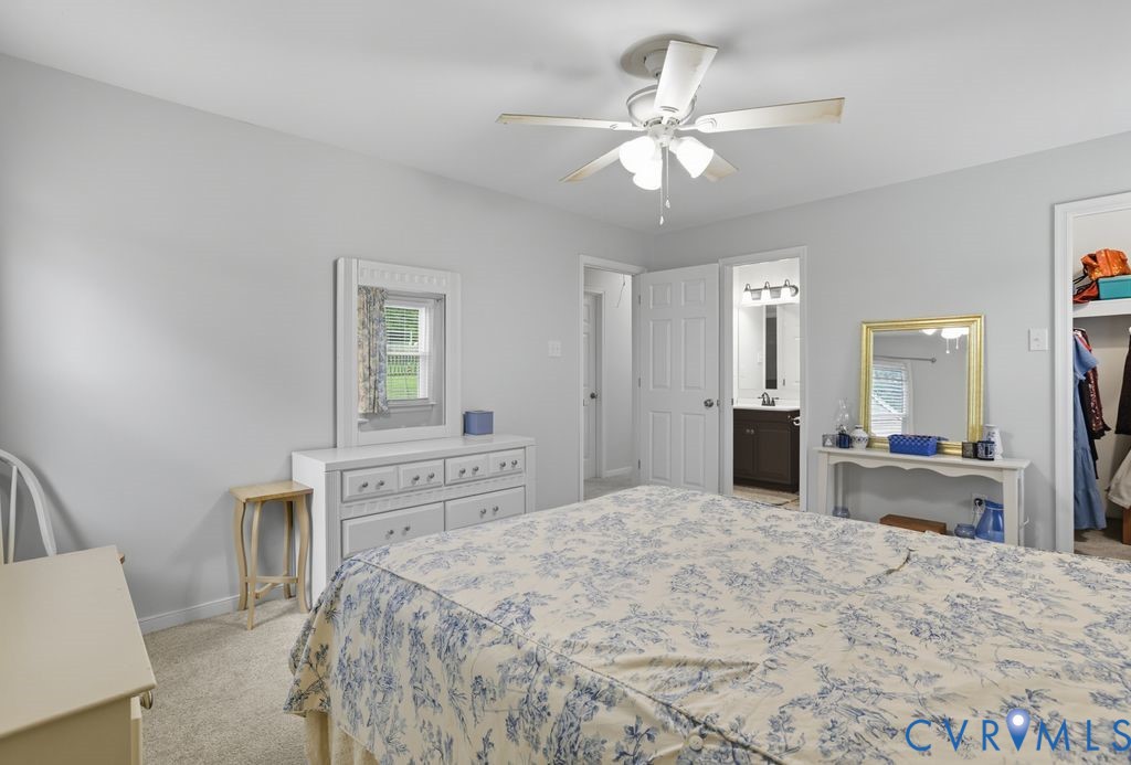 3403 Fallbrooke Court North Chesterfield, VA 23235 - Photo 15 of 23 a bedroom with a large bed and a chandelier