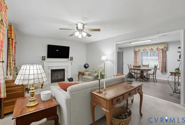 a living room with furniture a fireplace and a flat screen tv