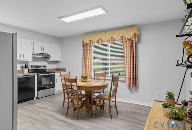 a view of a dining room with furniture and wooden floor