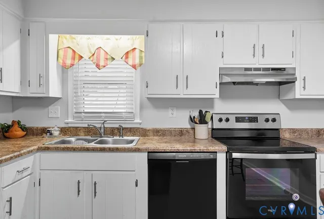 a kitchen with stainless steel appliances granite countertop a sink stove and cabinets