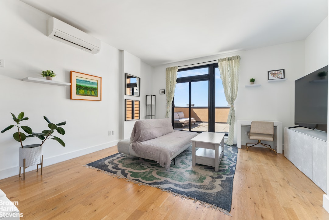 a living room with furniture rug and window