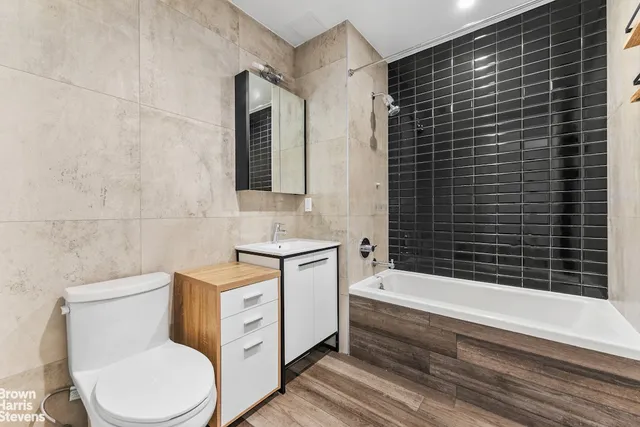 a bathroom with a toilet a sink and bathtub