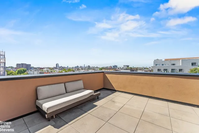a view of sitting area with furniture and city view