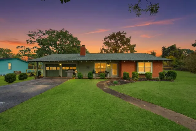 a front view of a house with a garden and porch