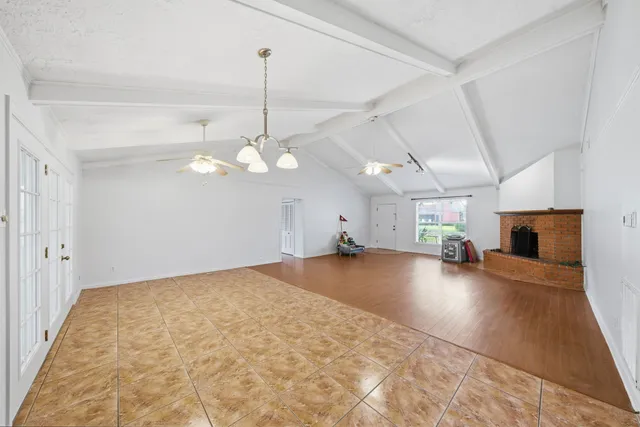 a kitchen with stainless steel appliances kitchen island granite countertop a refrigerator and a sink