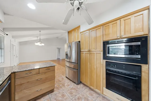 a kitchen with stainless steel appliances granite countertop a stove and a sink