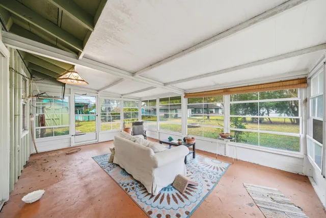 a living room with furniture and floor to ceiling windows