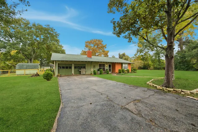 a front view of house with yard and green space