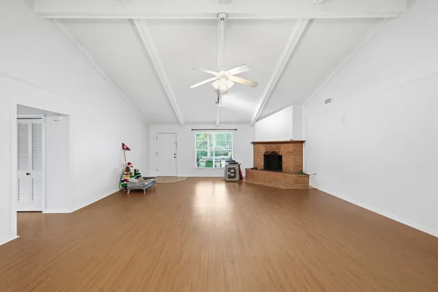 wooden floor in an empty room with a fireplace