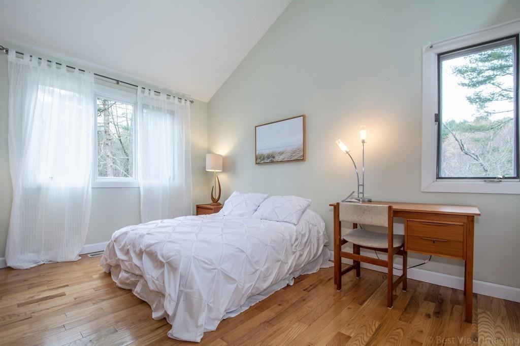 51 Cobleigh Road Boxborough, MA 01719 - Photo 19 of 32 a bedroom with a bed a table and painting on the wall