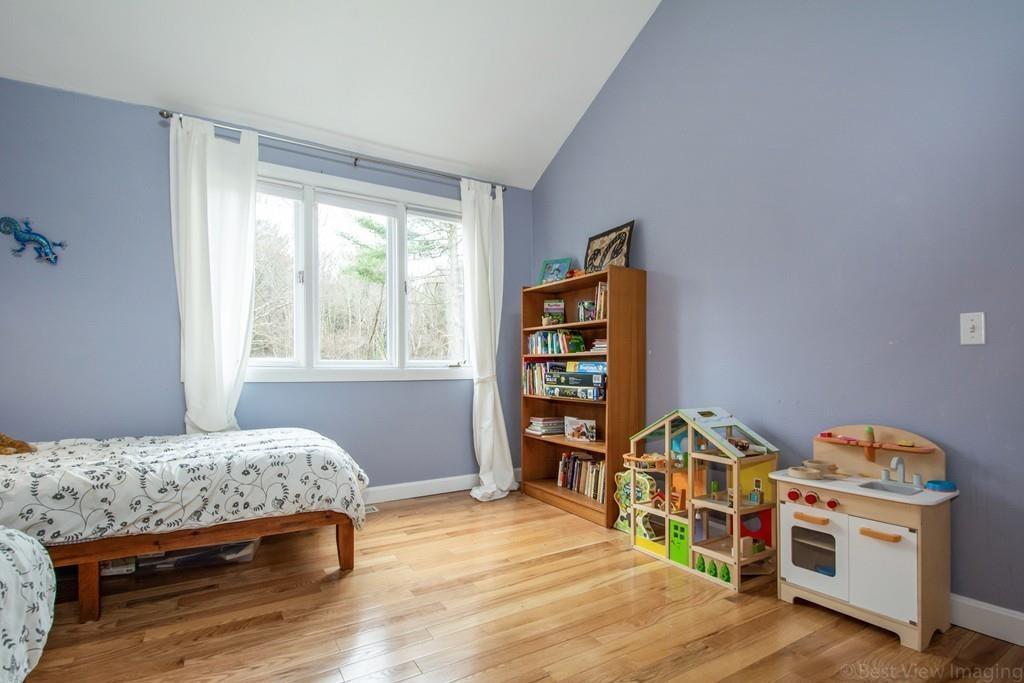51 Cobleigh Road Boxborough, MA 01719 - Photo 22 of 32 a bedroom with a bed and a book shelf
