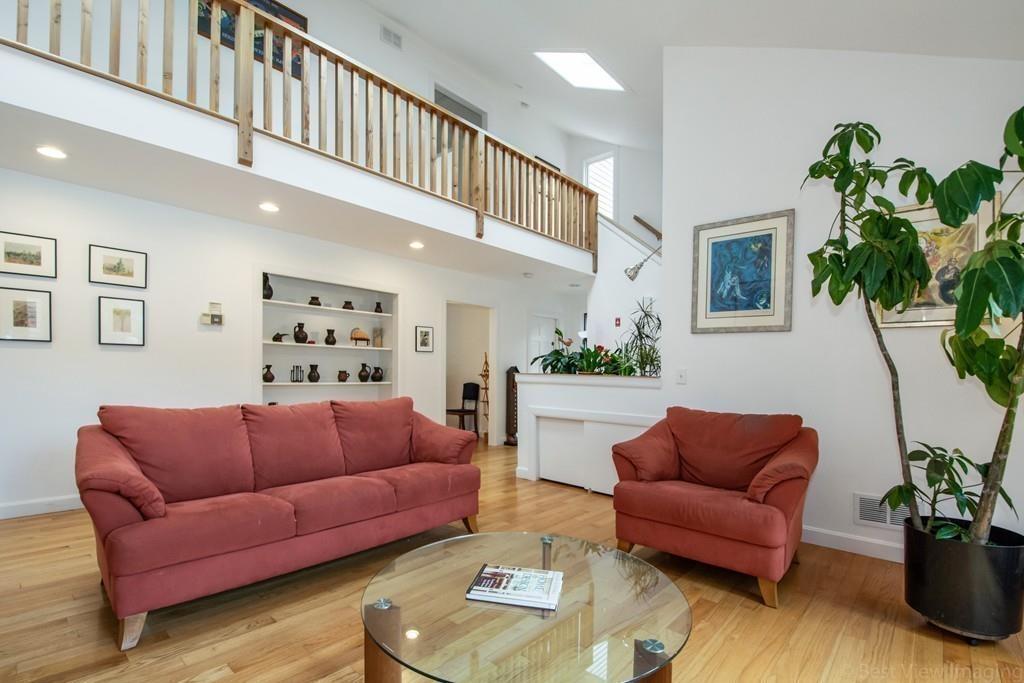 51 Cobleigh Road Boxborough, MA 01719 - Photo 4 of 32 a living room with furniture a rug and a potted plant