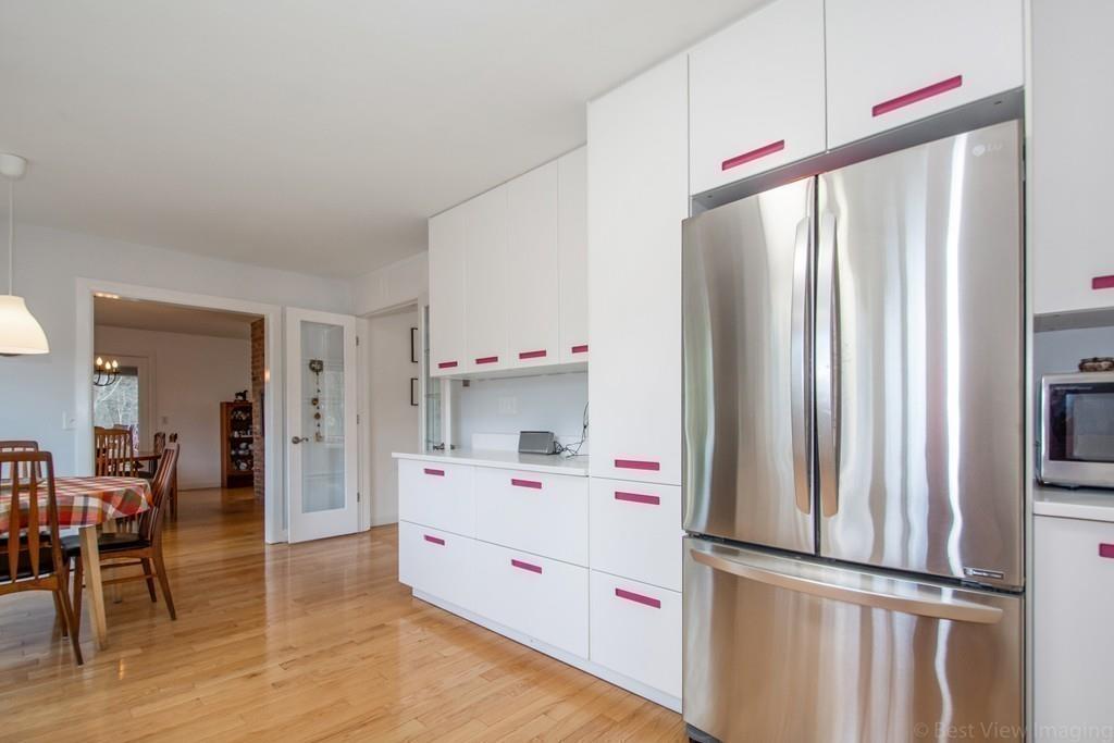 51 Cobleigh Road Boxborough, MA 01719 - Photo 5 of 32 a kitchen with stainless steel appliances a refrigerator sink and wooden floor