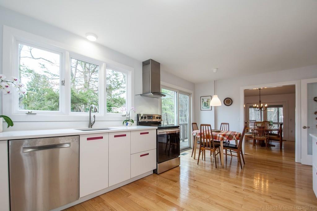 51 Cobleigh Road Boxborough, MA 01719 - Photo 6 of 32 a kitchen with lots of counter top space and dining table