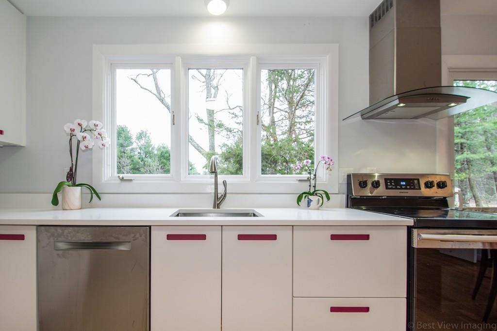 51 Cobleigh Road Boxborough, MA 01719 - Photo 8 of 32 a kitchen with stainless steel appliances a sink a counter tops and a window