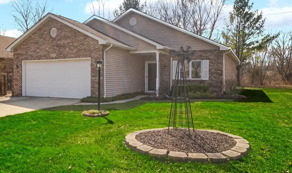 a view of a house with a backyard