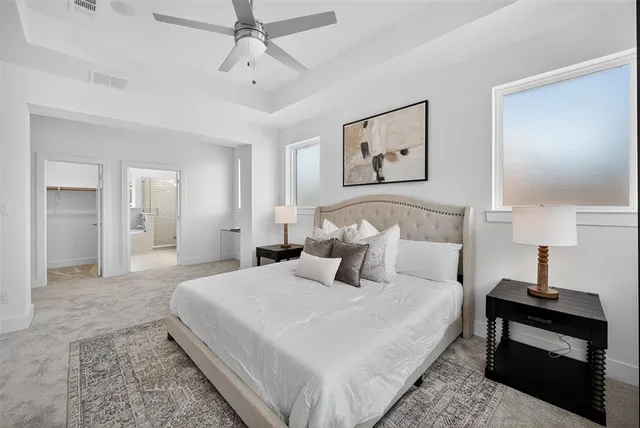 a bedroom with a large bed and a window