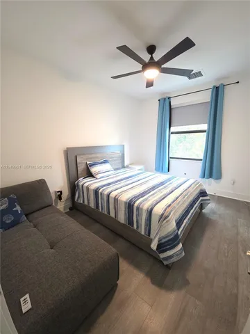 a bedroom with two beds and lamps