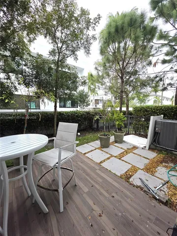 a view of backyard of house with seating space