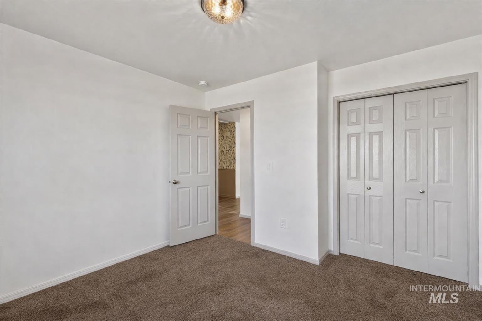 12781 Ashfield Street Caldwell, ID 83607 - Photo 26 of 36 Unfurnished bedroom featuring a closet and dark carpet