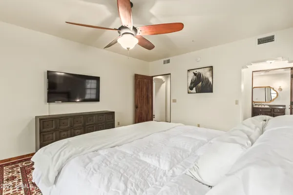 a bedroom with a bed and a flat screen tv