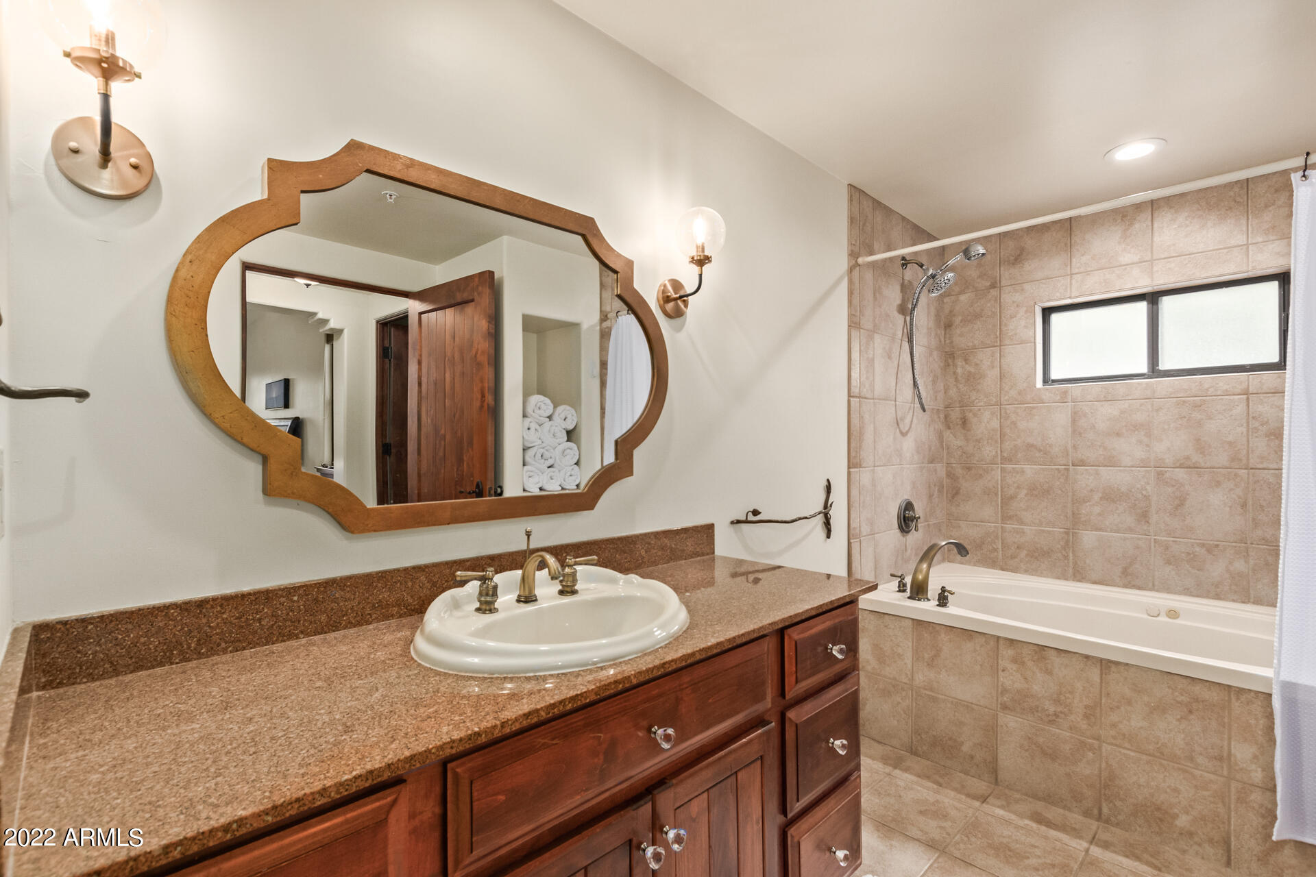 36601 North Mule Train Road, Unit A23 Carefree, AZ 85377 - Photo 12 of 26 a bathroom with a sink and a mirror