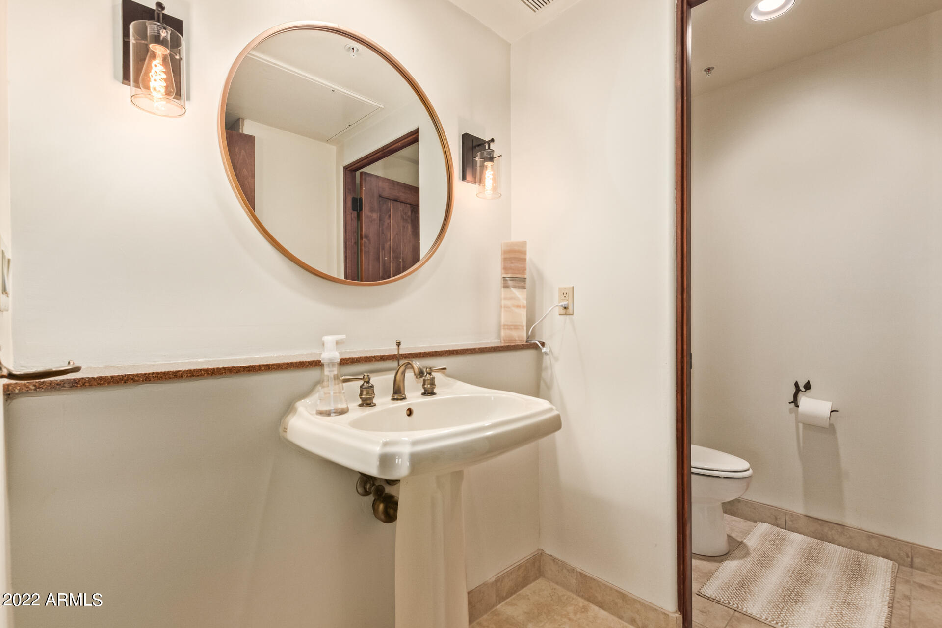 36601 North Mule Train Road, Unit A23 Carefree, AZ 85377 - Photo 15 of 26 a bathroom with a sink and a mirror