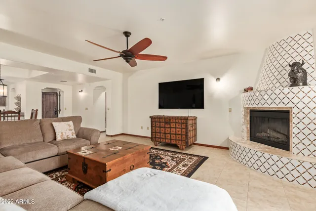 a living room with furniture a flat screen tv and a fireplace