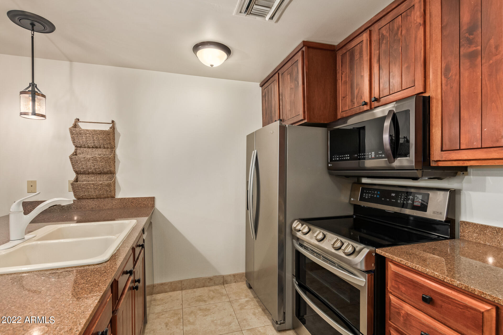 36601 North Mule Train Road, Unit A23 Carefree, AZ 85377 - Photo 6 of 26 a kitchen with stainless steel appliances granite countertop a sink stove and refrigerator