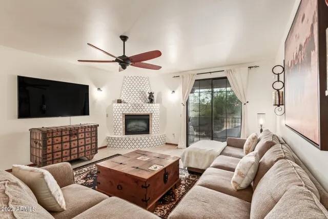 a living room with furniture fireplace and flat screen tv