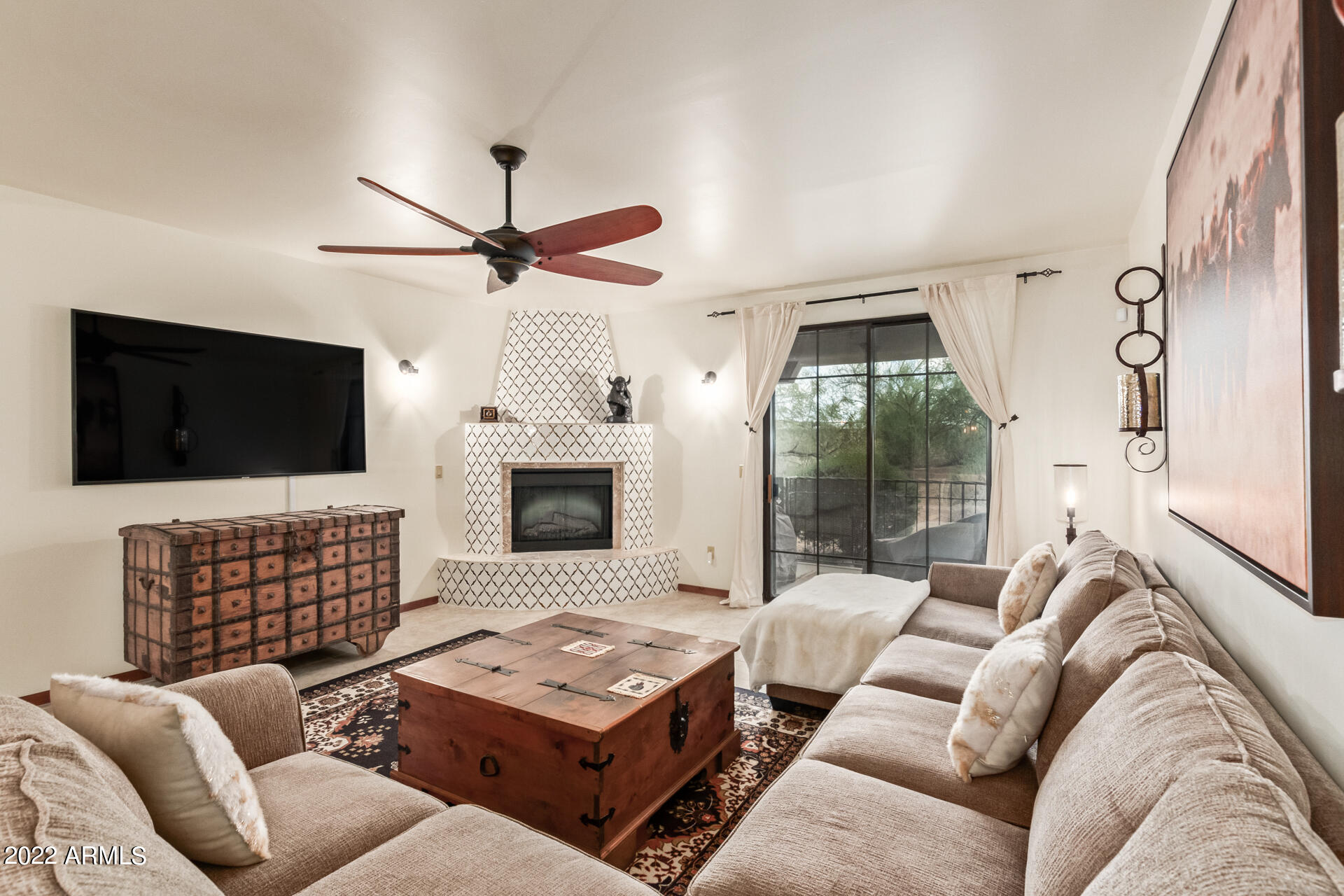 36601 North Mule Train Road, Unit A23 Carefree, AZ 85377 - Photo 7 of 26 a living room with furniture fireplace and flat screen tv