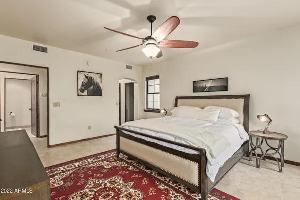 a bedroom with a bed and a chandelier