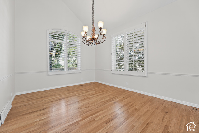 10664 Trail Ridge Circle Sandy, UT 84092 - Photo 9 of 113 Vaulted ceiling with a decorative chandelier, hardwood flooring, and white plantation shutters