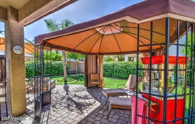 a view of an outdoor sitting area with furniture and backyard