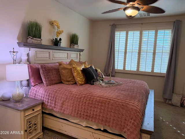 a bedroom with a bed and a lamp