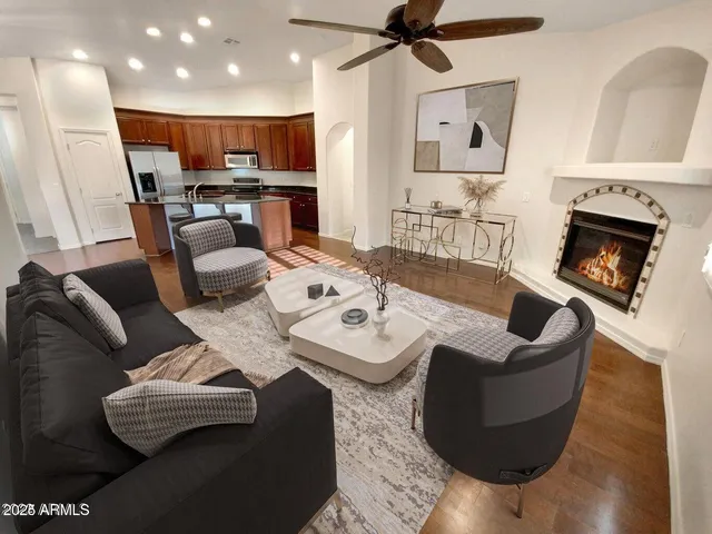 a living room with furniture and a wooden floor