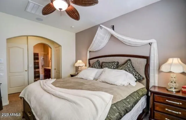 a bedroom with a bed and a chandelier