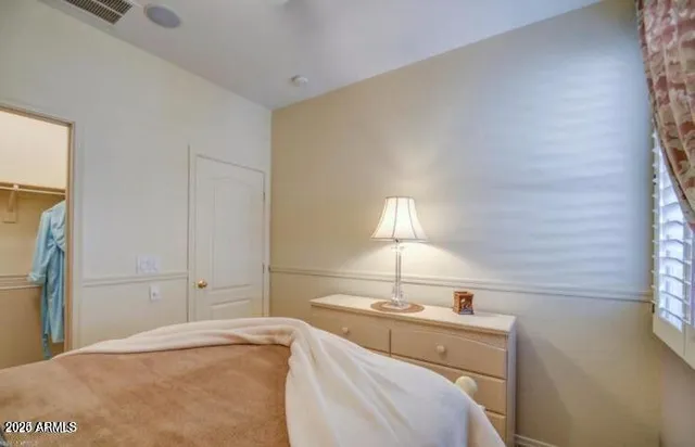 a bedroom with a bed and a lamp