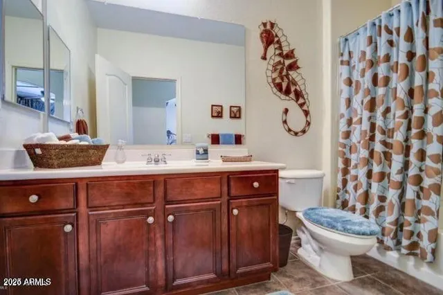 a bathroom with a sink a toilet and a mirror