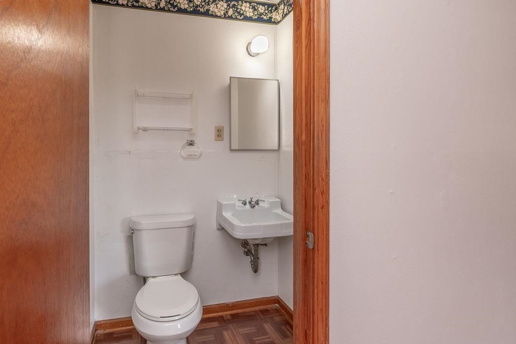 5595 Raleigh Lagrange Road Memphis, TN 38134 - Photo 18 of 29 a white toilet sitting next to a bathroom sink