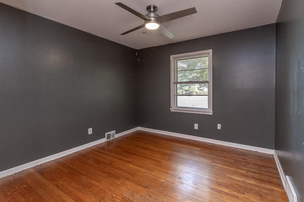 5595 Raleigh Lagrange Road Memphis, TN 38134 - Photo 21 of 29 wooden floor in an empty room with a window