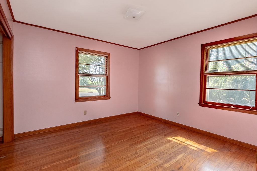 5595 Raleigh Lagrange Road Memphis, TN 38134 - Photo 24 of 29 a view of an empty room with wooden floor and a window