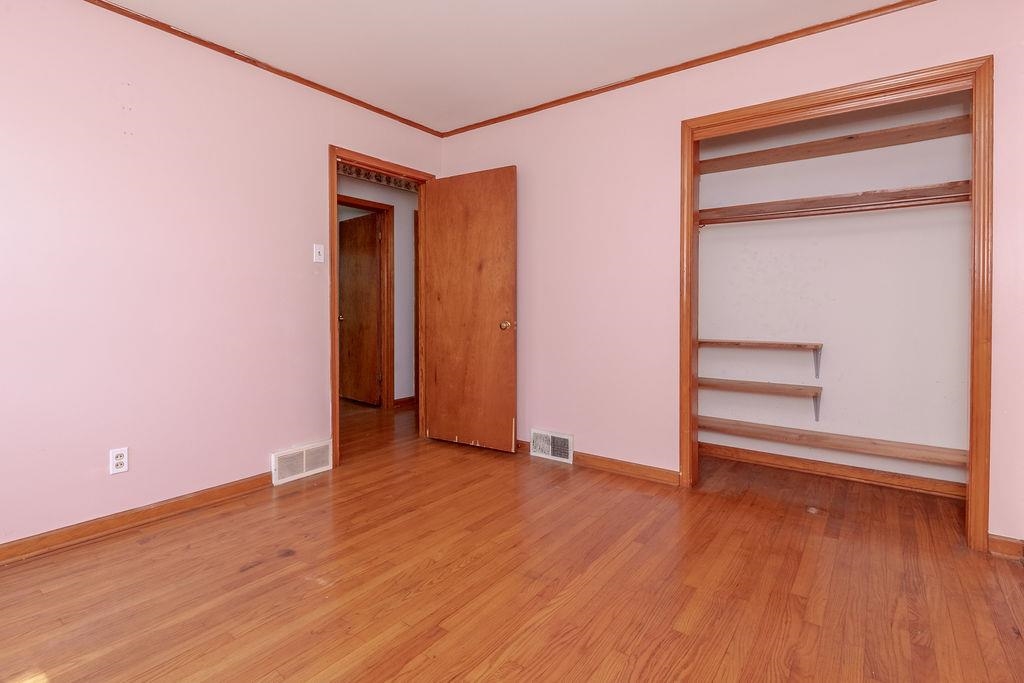 5595 Raleigh Lagrange Road Memphis, TN 38134 - Photo 25 of 29 an empty room with wooden floor and closet