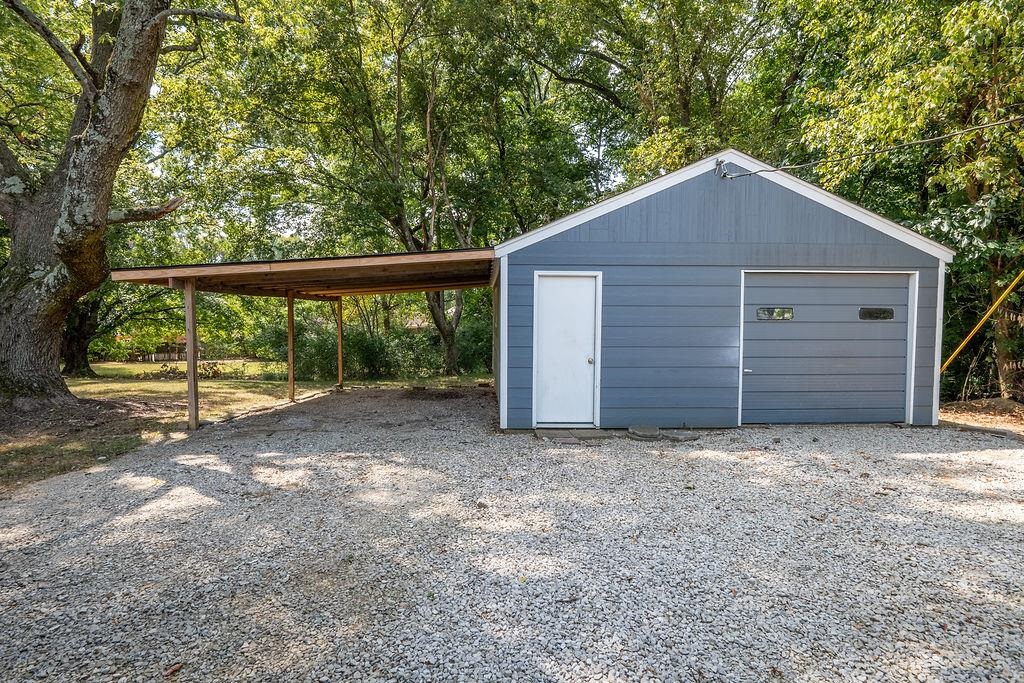 5595 Raleigh Lagrange Road Memphis, TN 38134 - Photo 5 of 29 a view of a house with a yard and garage